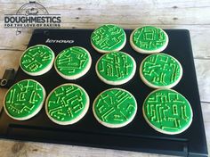 green frosted cupcakes sitting on top of a black tray