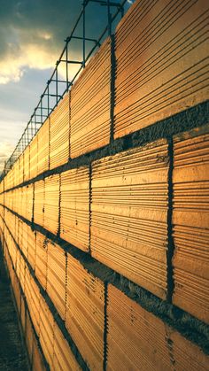 the wooden boards are stacked on top of each other in order to be used for construction