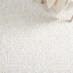 a white rug with an intricate design on it