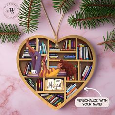 a heart shaped book shelf with books on it and an ornament that says personalize with your name