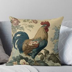 a rooster sitting on top of a couch next to a flowered wallpaper throw pillow