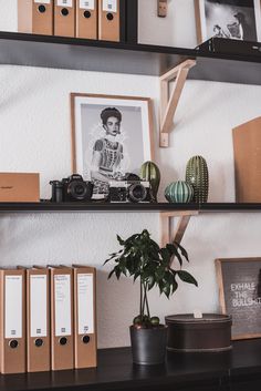 the shelves are filled with books, pictures and other things to collect in their home