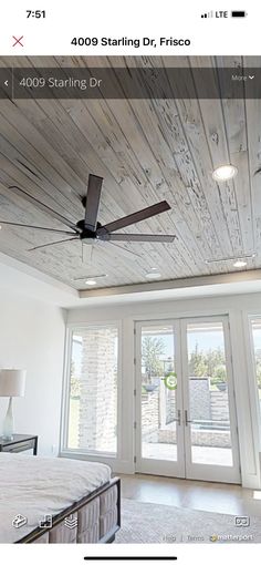 a bedroom with a ceiling fan and sliding glass doors