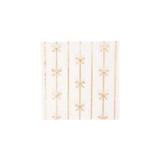 a white and gold napkin with bows on it