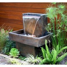 a water fountain in the middle of a garden