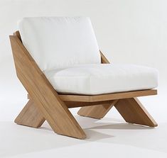 a wooden chair with white cushions on it