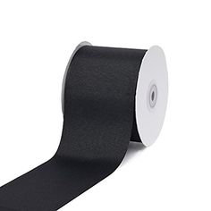 a roll of black satin ribbon on a white background