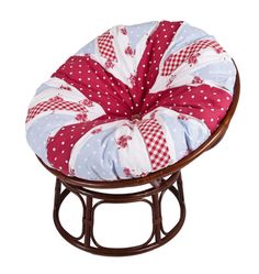 a red, white and blue patchwork chair cushion on a metal stand with polka dots