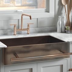 a kitchen sink that has some utensils in it