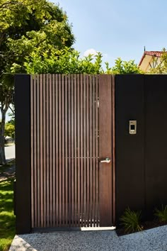 an open wooden gate in front of a house