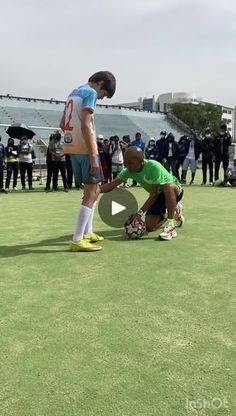 two soccer players kneel down on the field