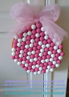 a door hanger with pink and white candies on it