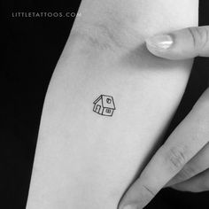 a small house tattoo on the left inner arm by littletattoos com, via littletattoos com