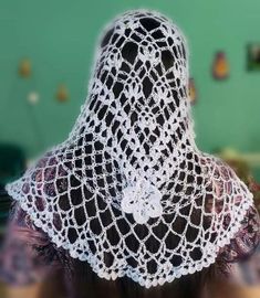 the back of a woman's head wearing a lace veil