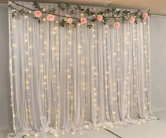 the curtain is decorated with flowers and lights