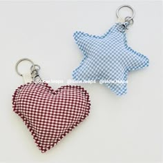 two heart shaped keychains with gingham checkered fabric, one in the shape of a star