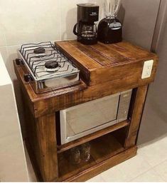 a microwave oven sitting on top of a wooden shelf next to a coffee pot and blender