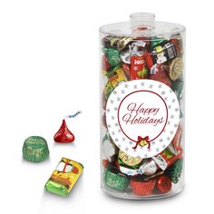 a glass jar filled with assorted candies next to a candy bar wrapper