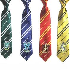 four harry potter ties are lined up in a row on a white background, one with the hogwart's crest