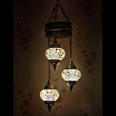 three lights hanging from a ceiling in a room