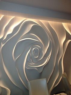 a large white rose on the wall in a living room with chairs and a table