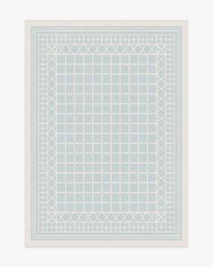 a blue and white square rug with circles on the border, in front of a white background