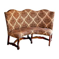 a brown and white patterned couch sitting on top of a wooden frame with an arm rest