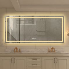 a bathroom with two sinks and a large mirror above the sink is illuminated by lights