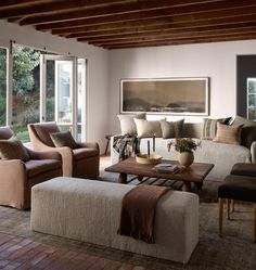 a living room filled with furniture and lots of windows