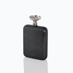 a black flask with a silver plate on top