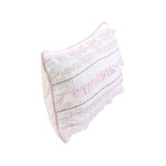 a pink and white pillow with ruffles on the bottom, against a white background