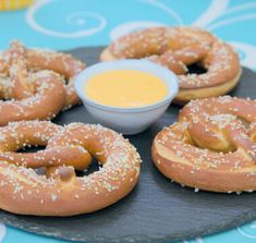 several pretzels on a plate with dipping sauce