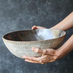 a person holding a bowl in their hands