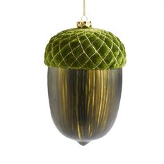 an acorn ornament hanging from a gold - plated metal object with green velvet covering