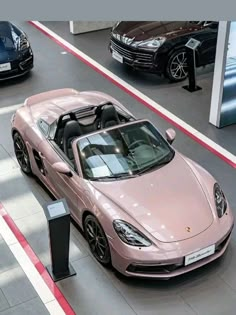 a pink sports car parked next to a parking meter