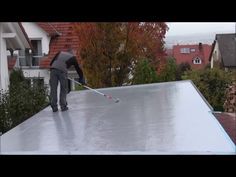 a man is cleaning the roof of his house