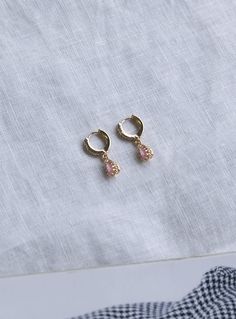 Dainty earrings Princess Polly exclusive One pair Mini hoops Pink drop charm Faux diamante detailing Latch fastening Gold toned hardware High shine finish Length: 2cm / 0.78” 60% brass, 40% zircon Queen Earrings, Original Necklace, Ice Queen, Gold Sunglasses, Dainty Earrings, Online Earrings, Hair Tools, Princess Polly, Sales Gifts