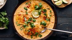 a pan filled with food and garnished with cilantro on the side