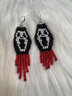 black and white beaded earrings with red tassels