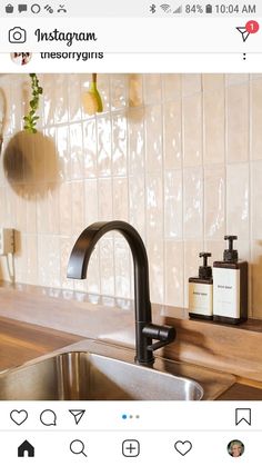 a kitchen sink with soap dispenser and toothbrushes on the counter