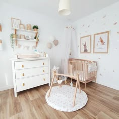 a baby's room with white walls and wooden floors