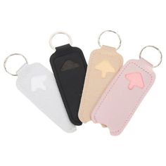 four different colored luggage tags are shown with one keychain attached to the other