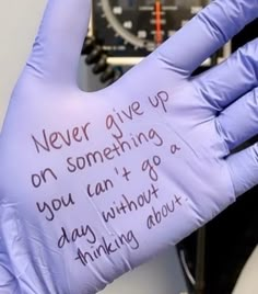 a glove with writing on it that says never give up on something you can't go days without thinking about