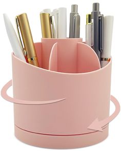 a pink pen holder with pens and pencils in it