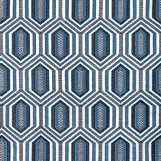 a blue and white pattern on fabric with hexagons in the center,