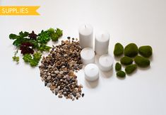 candles, rocks and plants are arranged on a white surface with the words supplies above them