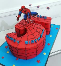 a spiderman birthday cake with the number five on it