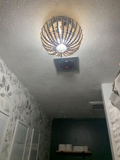 a bathroom light that is on in the ceiling