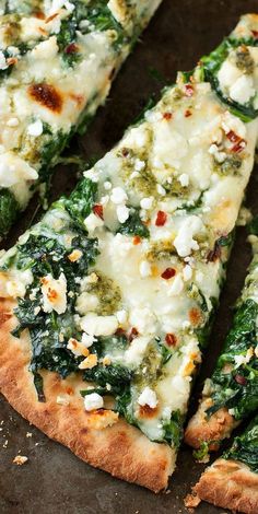 several slices of pizza with cheese and spinach