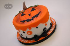 an orange and white cake with a jack - o'- lantern design on it